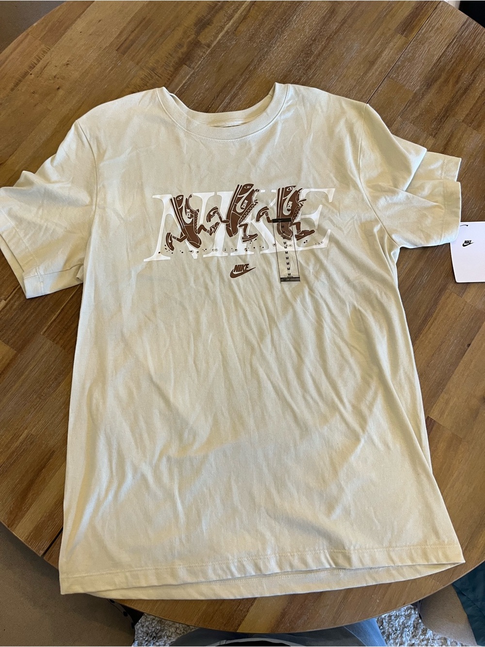 Nike Short-Sleeve Logo Tee in Cream with Brown Graphic